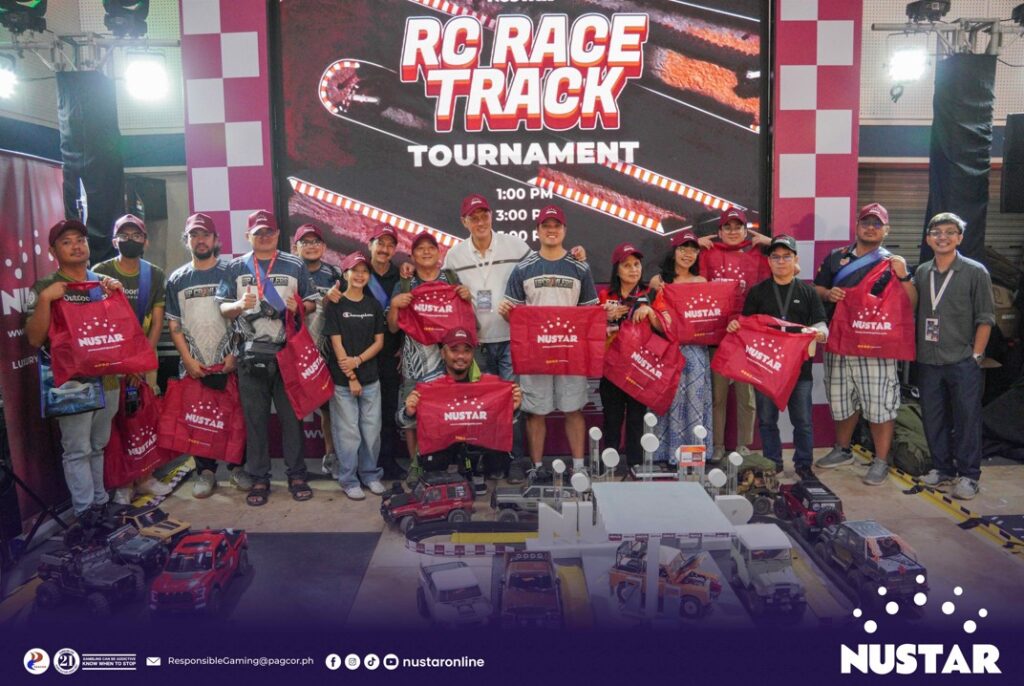 rc car enthusiasts and casual visitors take part in a group photo after enjoying the tournament at the nustar online rc car race booth